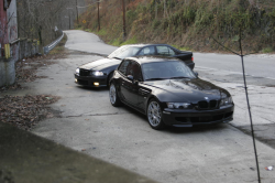 1999 BMW M Coupe in Cosmos Black Metallic over Imola Red & Black Nappa - Front 3/4